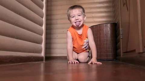 Very happy two year old child boy is lying on floor and playing with a toy car. Stock Footage 99474918
