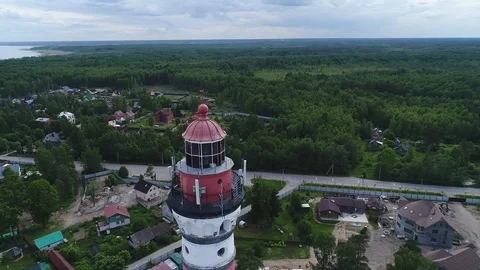 Very high lighthouse in white and red colors standing on the Ladoga coast. Stock Footage 100681709