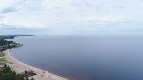 Very high lighthouse in white and red colors standing on the Ladoga coast. Stock Footage 100689529