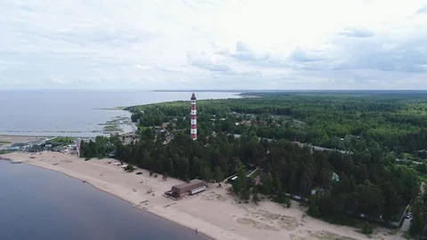 Very high lighthouse in white and red colors standing on the Ladoga coast. Stock Footage 100689532