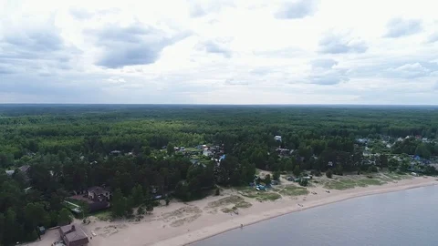 Very high lighthouse in white and red colors standing on the Ladoga coast. Stock Footage 100689575