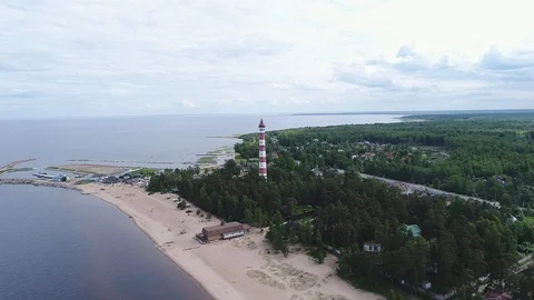 Very high lighthouse in white and red colors standing on the Ladoga coast. Stock Footage 100689691