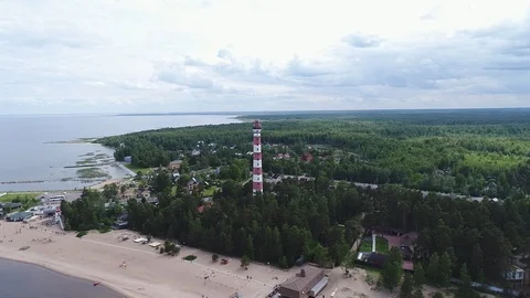 Very high lighthouse in white and red colors standing on the Ladoga coast. Stock Footage 100689811