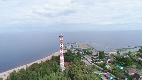 Very high lighthouse in white and red colors standing on the Ladoga coast. Stock Footage 100689813