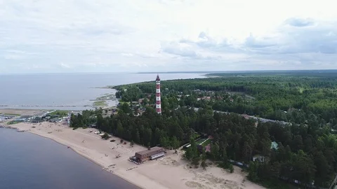 Very high lighthouse in white and red colors standing on the Ladoga coast. Stock Footage 100689821