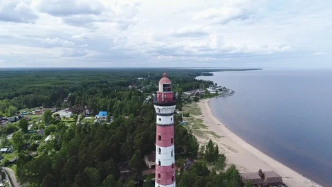 Very high lighthouse in white and red colors standing on the Ladoga coast. Stock Footage 100689839