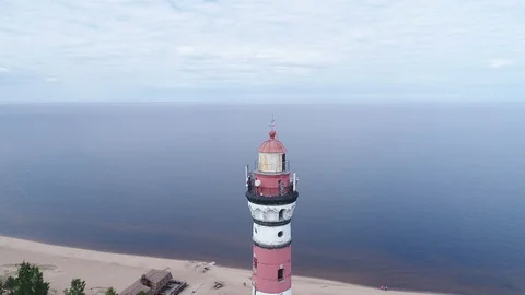Very high lighthouse in white and red colors standing on the Ladoga coast. Stock Footage 100689854