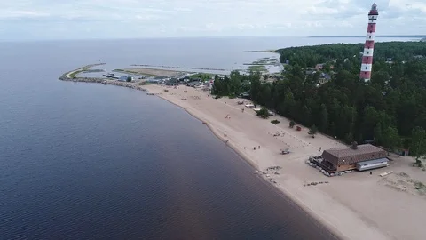 Very high lighthouse in white and red colors standing on the Ladoga coast. Stock Footage 100689923