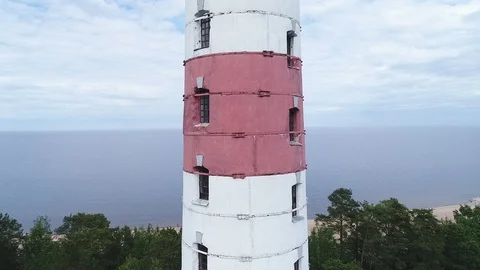 Very high lighthouse in white and red colors standing on the Ladoga coast. Stock Footage 100689927