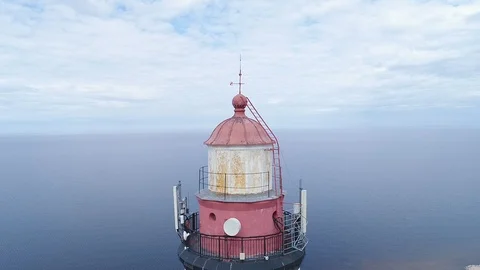 Very high lighthouse in white and red colors standing on the Ladoga coast. Stock Footage 100689929