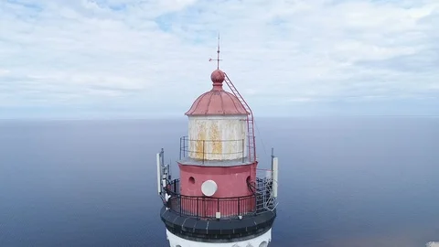 Very high lighthouse in white and red colors standing on the Ladoga coast. Stock Footage 100689972