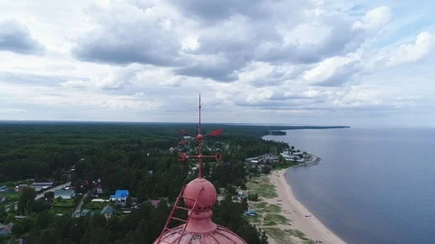 Very high lighthouse in white and red colors standing on the Ladoga coast. Stock Footage 100690019