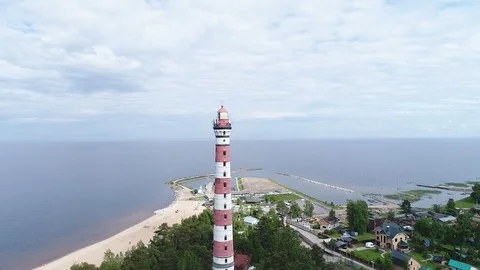 Very high lighthouse in white and red colors standing on the Ladoga coast. Stock Footage 100690046