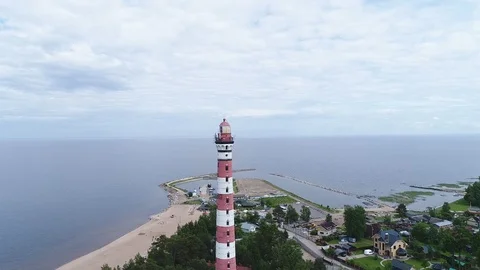 Very high lighthouse in white and red colors standing on the Ladoga coast. Stock Footage 100690118