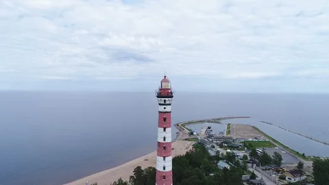 Very high lighthouse in white and red colors standing on the Ladoga coast. Stock Footage 100690129