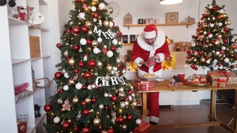 A very hungry Santa Claus eats Christmas gingerbread in the kitchen Stock Footage 165462741
