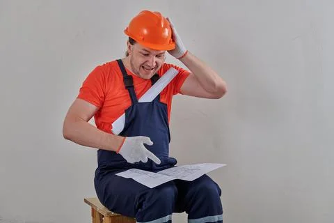 A very intelligent engineer examines the project drawings carefully Stock Photos