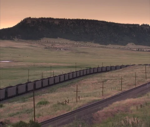 Very long coal train moves across landscape Stock Footage 86692747