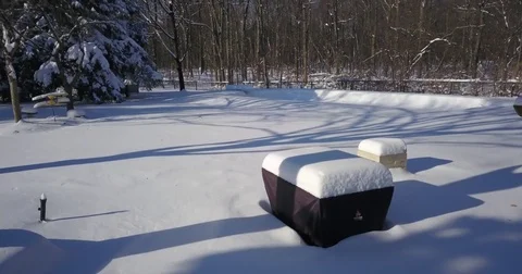 Very low altitude drone flight in pristine snow covered suburban backyard. Stock-Footage 83764565