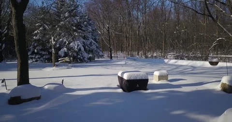 Very low altitude drone flight in pristine snow covered suburban backyard. Stock-Footage 83764738