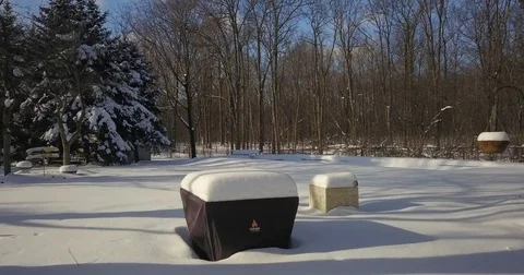 Very low altitude drone flight in pristine snow covered suburban backyard. Video stock 83795179