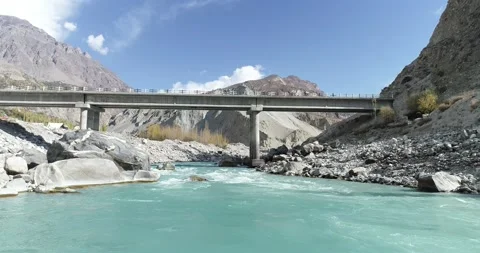 Very low shot of river with bridge in mountain Stock Footage 166366043
