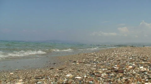 Very low shot of waves gently washing up onto the beach Stock Footage 78006