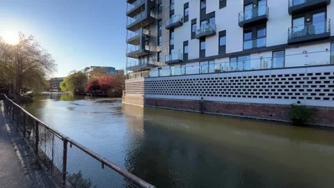 Very modern flats facing the river in the UK - gimbal shot on a sunset Stock-Footage 332620750