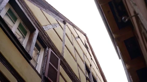 Very narrow street between two half-timbered houses, tilt up view, moving shot Video stock 99020177