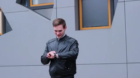 Very Nice Man Using Smart Watches. he Presses a Finger on the Screen, Standing 스톡 동영상 61179475