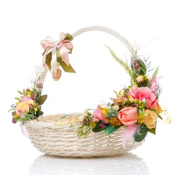 A very nice round white Easter basket with a bow on the handle and a variety  Stock Photos