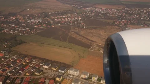Very nice video from the window of the plane. Flight over the city and the Stock Footage 107829221