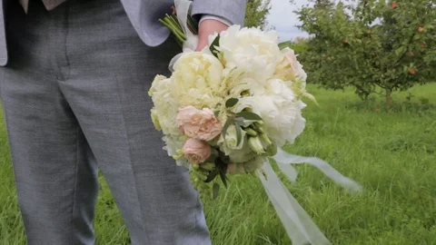 Very nice young man holding wedding flower bouquet Stock Footage 121082765