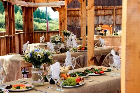 Very nicely decorated wedding table with plates and serviettes. Stock Photos