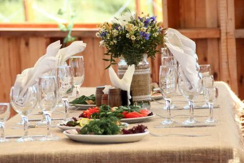 Very nicely decorated wedding table with plates and serviettes. Stock Photos