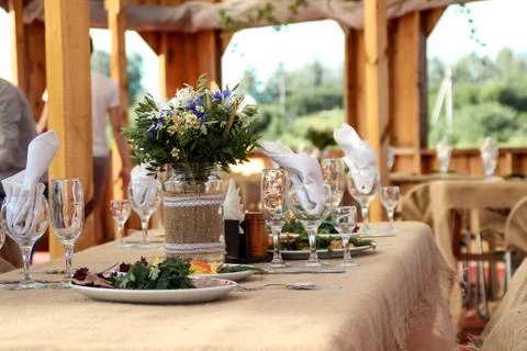 Very nicely decorated wedding table with plates and serviettes. Stock Photos