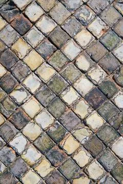 Very old and aged square tiles on the floor Stock Photos