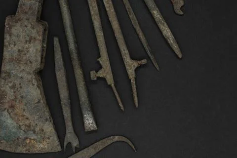 Very Old and Rusty Tools on Black Background with Free Space Stock Photos