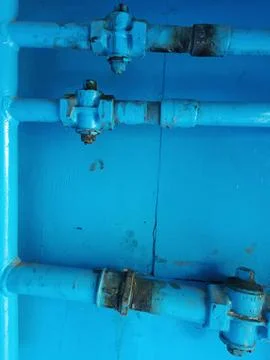 Very old dirty Pipe construction. Vertical and horizontal pipes with connecting Stock Photos