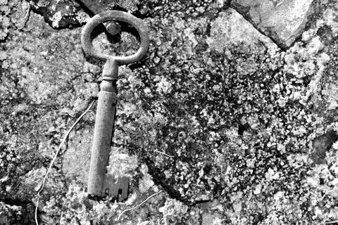 Very old door key in rusty iron Stock Photos