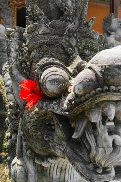 Very old dragon head shape stone sculpture covered with moss and lichens in B Stock Photos