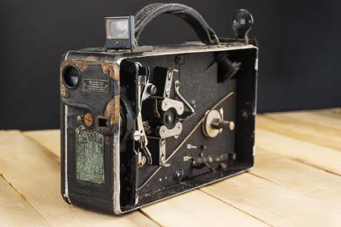Very old handheld video camera on wooden desk Foto stock