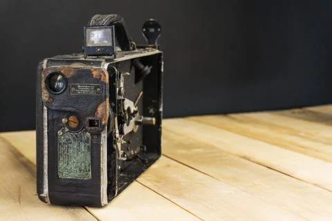 Very old handheld video camera on wooden desk Foto stock