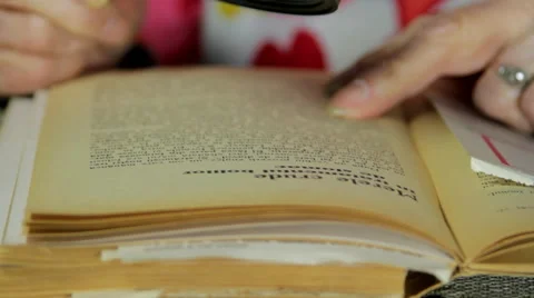 Very Old Lady Reading A Book With A Magnifying Glass, Hands Detail, Tilt Stock Footage 52339155
