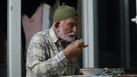 Very old man having dinner Stock Footage 260656264