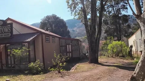 Very old mining town drive past old buildings Stock Footage 313815754