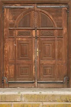 Very old solid wooden door in retro 19th century design close up Stock Photos