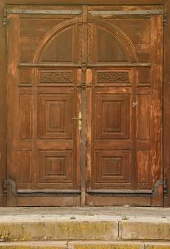 Very old solid wooden door in retro 19th century design close up Stock Photos