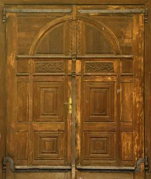 Very old solid wooden door in retro 19th century design close up Stock Photos