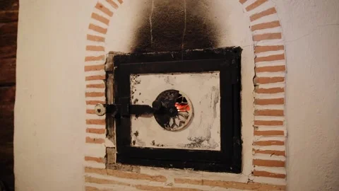 A very old stone oven in ancient house in mountains. A fire burns in a wood Stock Footage 226201728